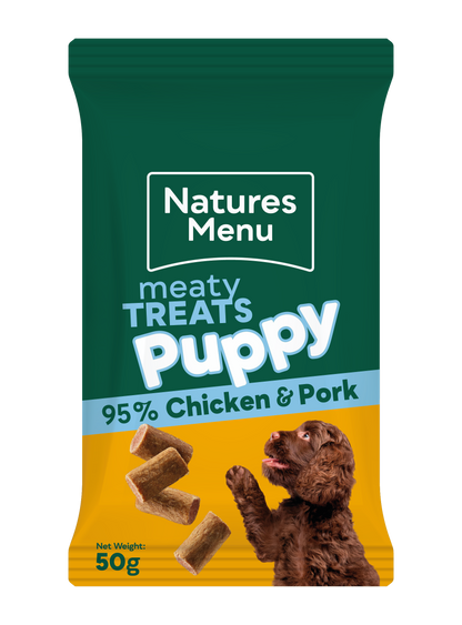 Natures Menu puppy treats packaging with a green top and yellow bottom, featuring chicken and pork.