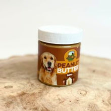 Jar of peanut butter for dogs on a wooden surface