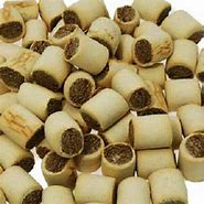 Assorted dog treats including bones and round pieces on a white background
